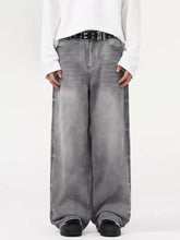 Men’s vintage wash wide leg gray denim jeans with faded distressed look and visible stitching details
