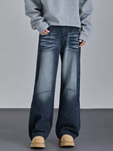 Men’s dark blue denim vintage wash wide leg jeans with distressed faded details and a wide-leg cut
