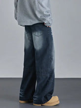 Men’s vintage wash wide leg dark-wash denim jeans with subtle fading and reinforced stitching on lower legs