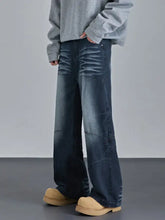 Men’s vintage wash wide leg jeans in dark-wash denim featuring subtle distressing and a relaxed wide-leg cut