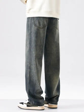 Men’s vintage wash wide leg jeans in dark-wash denim with a relaxed straight-leg cut and classic back pockets shown from the back