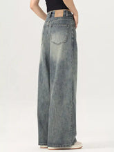 Men’s vintage wash wide leg jeans in faded blue denim with subtle distressing and classic back pocket design back view