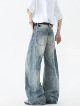 Men’s vintage wash wide leg jeans in faded blue denim with subtle distressing and reinforced stitching