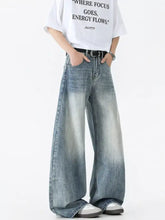Men’s vintage wash wide leg jeans in faded blue denim with rolled cuffs and a vintage wash wide design