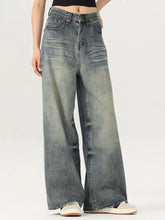 Men’s vintage wash wide leg jeans in faded blue denim with subtle distressing and classic stitching detail