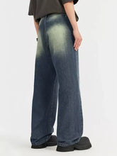 Men’s vintage wash wide leg jeans in denim with a faded gradient wash from dark blue to lighter greenish-blue
