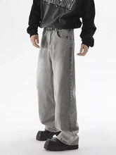 Men’s vintage wash wide leg gray denim jeans with faded wash and visible stitching along the seams