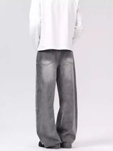 Men’s vintage wash wide leg gray denim jeans with a faded distressed finish and classic back pockets back side view