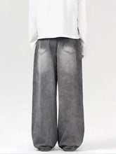 Men’s vintage wash wide leg gray denim jeans with faded distressed finish and classic back pockets back view