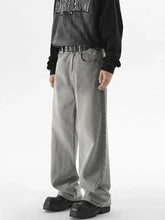 Men’s vintage wash wide leg jeans in gray denim with a faded distressed finish and visible seam stitching