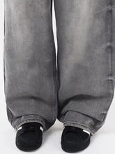 Men’s vintage wash grey wide leg denim jeans with a faded distressed finish and rolled cuffs