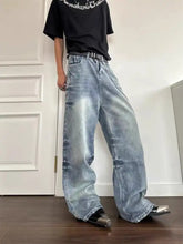 Men’s vintage wash wide leg jeans in light-wash denim with a faded distressed look and frayed hems