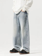 Men’s vintage wash wide leg denim jeans in light wash with a straight-cut silhouette and subtle fading for a modern look