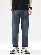 Men’s vintage washed dark-wash denim jeans with a relaxed fit straight leg and rolled cuffs