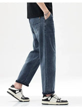 Men’s vintage washed dark-wash denim jeans with a relaxed fit straight leg and rolled cuffs for casual wear