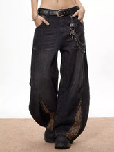 Men’s vintage wide leg black denim pants with snake print side panels and a studded belt