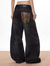 Men’s vintage wide leg black denim jeans back view with snake print patch on back pocket