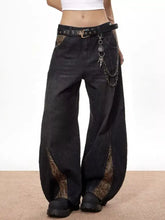 Men’s vintage wide leg black denim jeans with snake print side panels and a studded belt for stylish wear