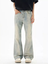 Men’s wash flare jeans in light-wash denim with a relaxed wide-leg cut and subtle fading for a vintage-inspired look