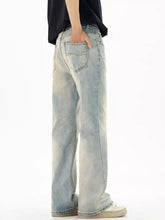 Men’s wash flare jeans in light-wash denim with a relaxed wide-leg cut and subtle fading for a modern casual look