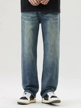 Blue denim men’s wash loose fit jeans with relaxed straight-leg cut and faded wash in loose fit jeans style