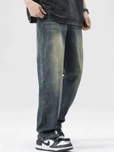 Men’s dark-wash denim loose fit jeans with a faded distressed look and relaxed fit for casual wear