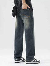 Men’s dark-wash denim loose fit jeans with a relaxed straight-leg cut and subtle fading along the thighs