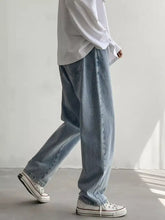 Men’s wash loose fit jeans in light-wash denim with a relaxed straight-leg cut for casual wear