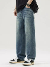 Men’s wash loose fit jeans in light-wash denim with a relaxed straight-leg cut and subtle fading for casual wear