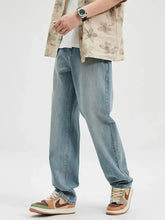 Men’s wash relaxed fit jeans in light-wash denim with a relaxed straight-leg cut and subtle fading on the thighs