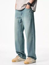 Men’s wash relaxed fit jeans in light-wash denim with a relaxed straight-leg cut and visible stitching details