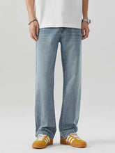Men’s light-wash denim jeans with a relaxed fit and straight-leg cut featuring classic stitching