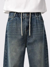 Men’s wash blue denim jeans with relaxed fit and white drawstrings for comfortable fit jeans style