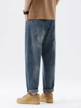 Men’s blue denim relaxed fit jeans with tapered fit and rolled cuffs for comfortable casual wear