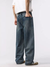Dark blue denim men’s wash relaxed fit jeans with elastic waistband and wide relaxed fit for comfort and style