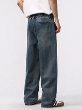 Mens dark-wash denim jeans with a relaxed fit wide-leg cut and elastic waistband ideal for casual wear