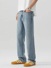Men’s wash relaxed fit jeans in light-wash denim with a relaxed straight-leg cut for casual wear