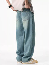 Men’s wash relaxed fit light-wash denim jeans shown from the back with a relaxed wide-leg cut and classic pockets