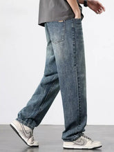 Men’s wash relaxed fit jeans in washed blue denim with a relaxed straight-leg cut and classic stitching