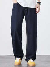 Men’s wash relaxed fit jeans in dark indigo cotton blend denim with relaxed fit and contrasting white stitching