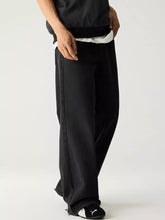 Men’s black puma track pants with relaxed fit wide leg cut and subtle side stripes for comfortable wear