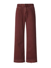 Men’s burgundy wide leg denim jeans with relaxed fit high waist and raw hem frayed edges