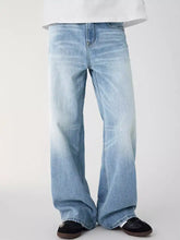 Men’s light-wash denim jeans with relaxed fit, wide-leg flared cut, and subtle fading for a contemporary look