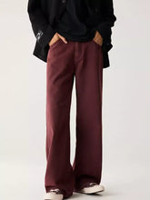 Men’s maroon wide leg jeans with relaxed fit and subtle stitching details featuring a raw hem finish