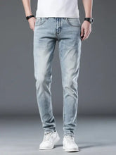 Men’s light-wash denim slim fit jeans with subtle fading and a modern tailored silhouette