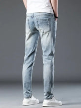 Back side of men’s light-wash slim fit denim jeans with barcelone homme logo embroidered on the back pocket
