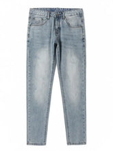 Men’s wash slim fit light-wash denim jeans with subtle fading and classic five-pocket design