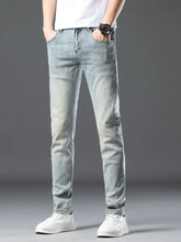 Men’s wash slim fit jeans in light-wash denim with a slim fit and subtle distressing along the thighs