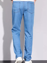 Men’s wash slim fit jeans in light blue denim with classic straight-leg cut and visible stitching