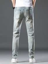 Light-wash denim men’s slim fit jeans shown from the back with classic back pockets and a slim-fit cut